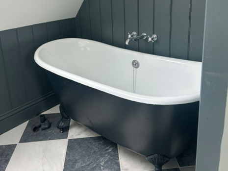 grey cast iron bath in monochrome bathroom